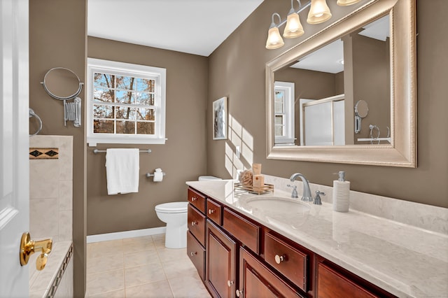 bathroom featuring tile patterned floors, vanity, an enclosed shower, and toilet