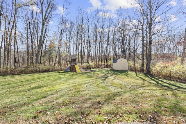 view of yard featuring a playground and a shed