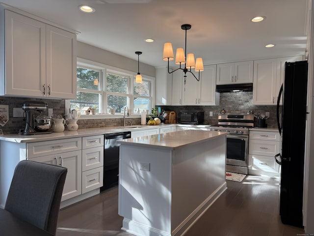 kitchen featuring black appliances, decorative light fixtures, a kitchen island, white cabinets, and dark wood-type flooring