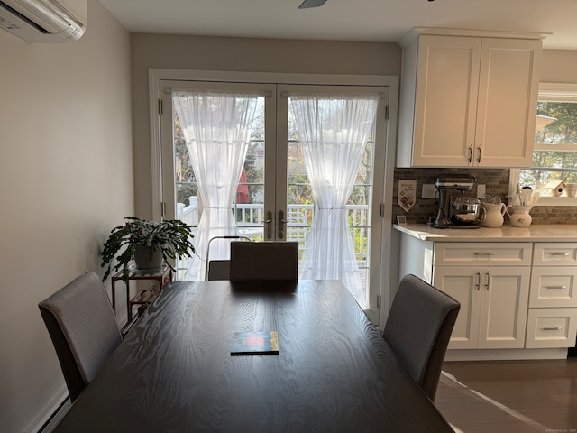 dining room featuring dark hardwood / wood-style flooring, a baseboard heating unit, and a wall mounted air conditioner