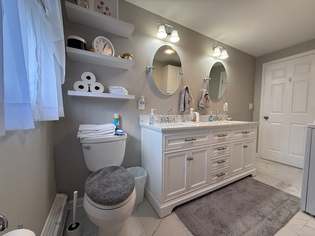 bathroom featuring toilet, radiator heating unit, and vanity