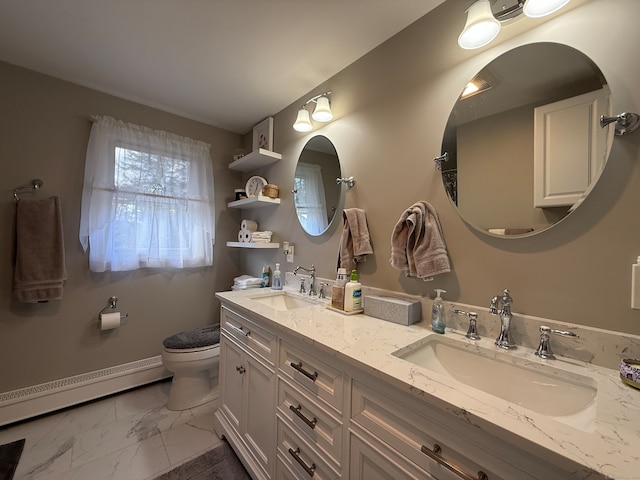 bathroom featuring toilet, vanity, and baseboard heating