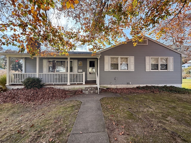 ranch-style home with a porch and a front yard