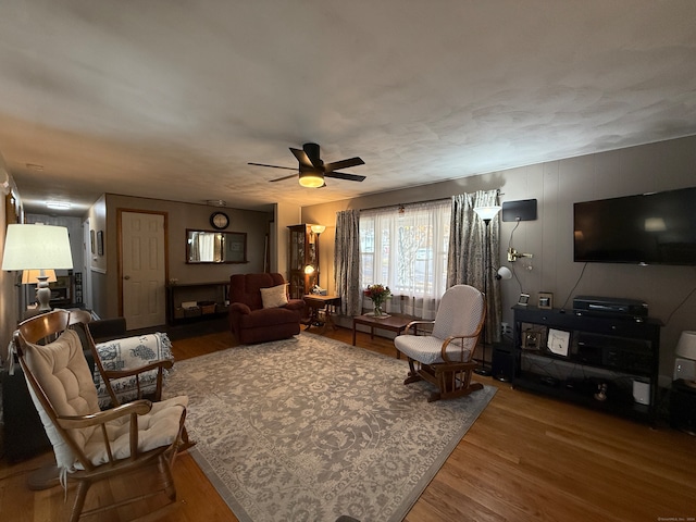 living room featuring hardwood / wood-style floors and ceiling fan