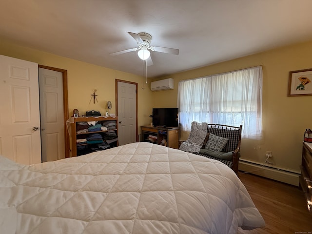 bedroom with ceiling fan, hardwood / wood-style flooring, a wall mounted AC, and a baseboard radiator