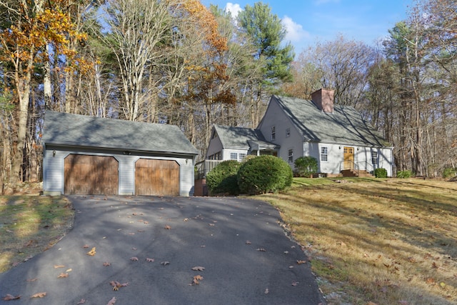 view of side of property featuring an outbuilding and a yard