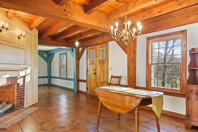 dining room with a brick fireplace, beamed ceiling, and wood ceiling