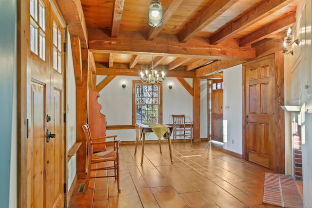 living area with a chandelier, beam ceiling, wood ceiling, and light hardwood / wood-style flooring