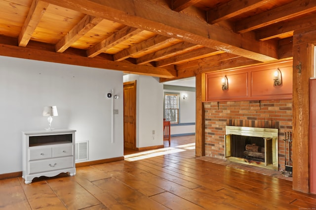 unfurnished living room featuring light wood-type flooring, wood ceiling, beam ceiling, and a fireplace