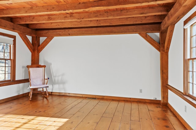 interior space featuring a wealth of natural light, wood ceiling, light hardwood / wood-style floors, and beam ceiling