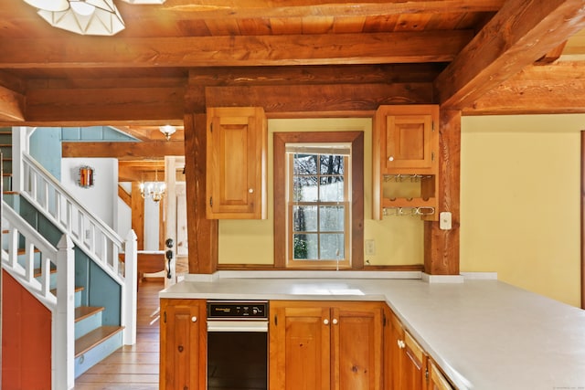 kitchen with light hardwood / wood-style floors, wood ceiling, kitchen peninsula, a chandelier, and beam ceiling