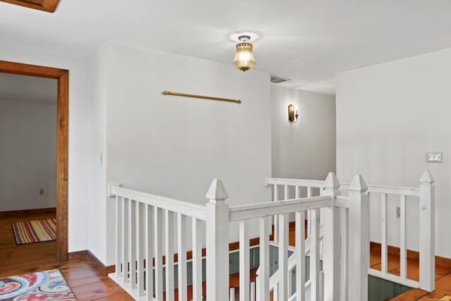 corridor with hardwood / wood-style floors