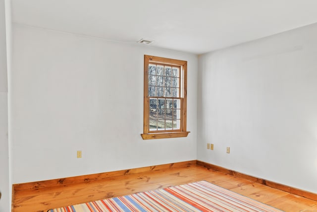 unfurnished room with hardwood / wood-style floors