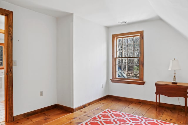 interior space featuring light hardwood / wood-style floors and lofted ceiling