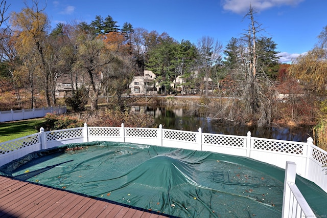 view of swimming pool with a water view