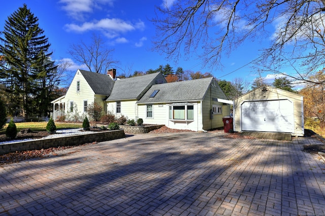 view of front of home with a garage and an outdoor structure