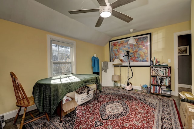 bedroom with hardwood / wood-style flooring, ceiling fan, and lofted ceiling