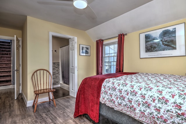 bedroom featuring dark hardwood / wood-style flooring, lofted ceiling, and ceiling fan