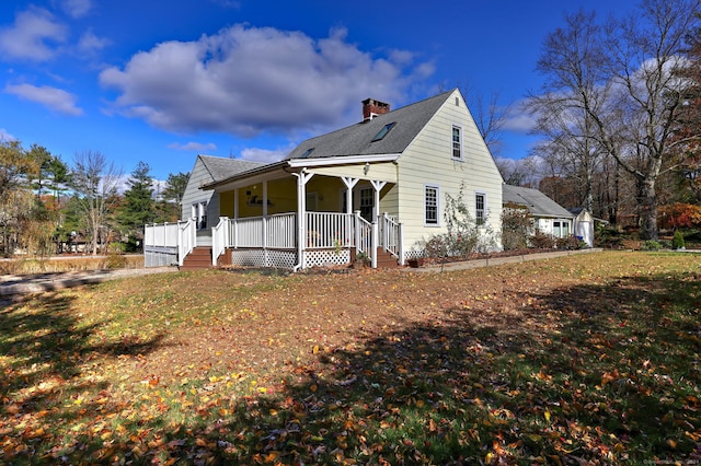 view of front of house with a front yard and a porch