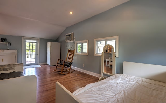 bedroom featuring access to outside, white fridge, washer / clothes dryer, hardwood / wood-style flooring, and lofted ceiling