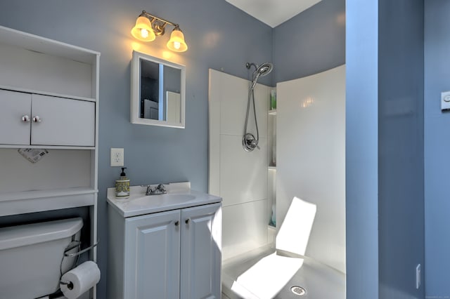 bathroom with walk in shower, vanity, and toilet