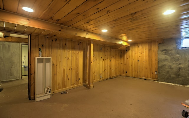 basement with wooden walls, wooden ceiling, and carpet floors