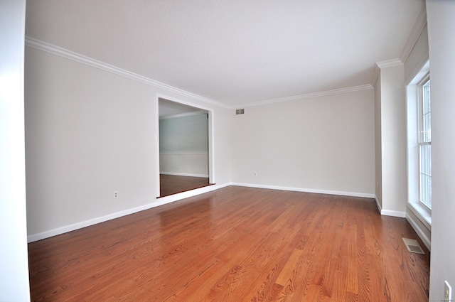 unfurnished room featuring crown molding and hardwood / wood-style floors