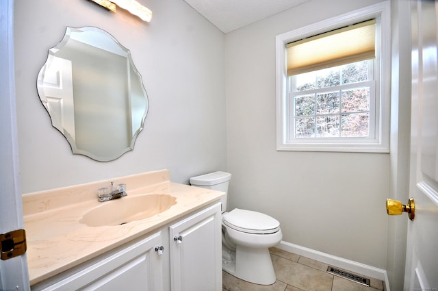 bathroom featuring tile patterned floors, vanity, and toilet