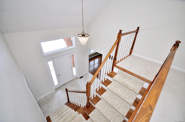 entrance foyer featuring an inviting chandelier and high vaulted ceiling