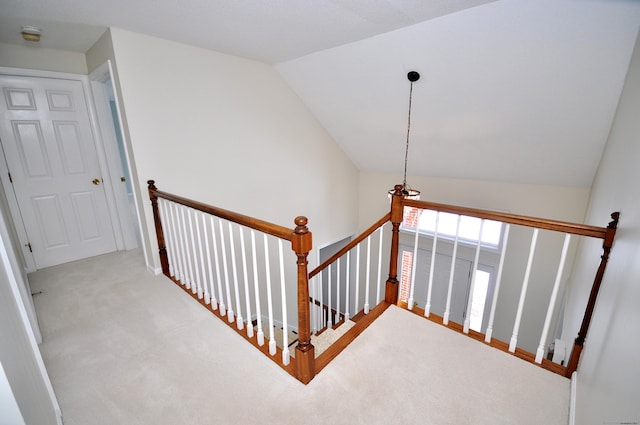 stairs with vaulted ceiling and carpet