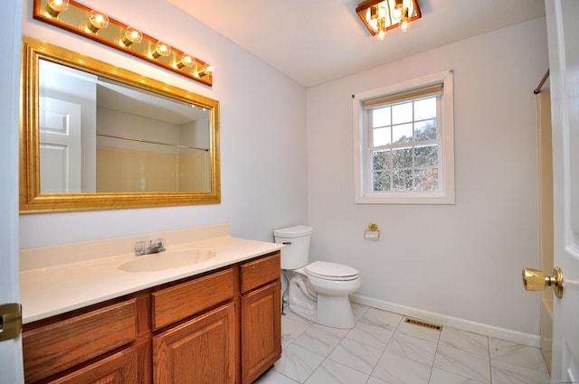 bathroom featuring walk in shower, vanity, and toilet