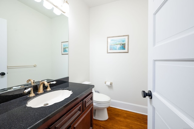 bathroom featuring hardwood / wood-style floors, vanity, and toilet