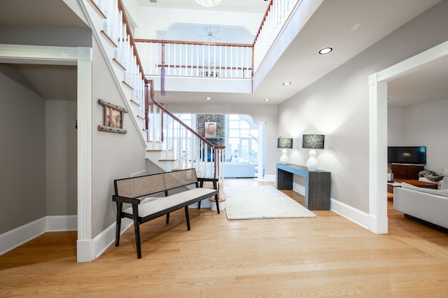 foyer entrance with light hardwood / wood-style floors and a high ceiling