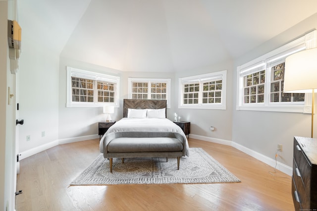 bedroom with light hardwood / wood-style flooring and vaulted ceiling