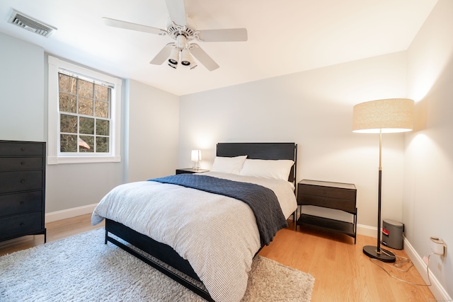 bedroom with ceiling fan and light wood-type flooring