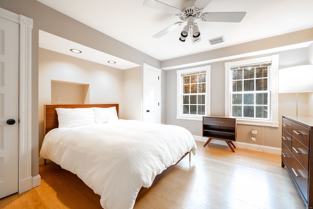 bedroom with light wood-type flooring and ceiling fan