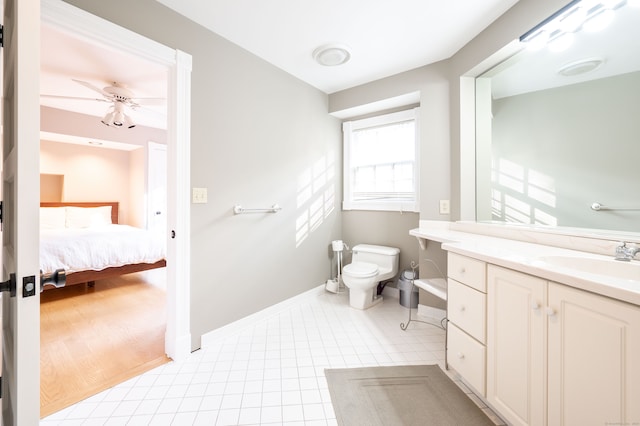 bathroom with toilet, vanity, hardwood / wood-style floors, and ceiling fan