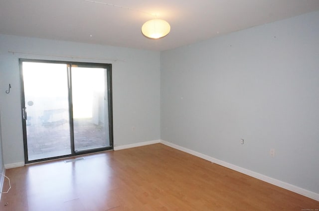 spare room featuring light wood-type flooring