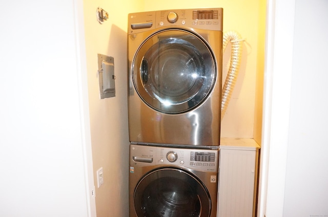 washroom featuring stacked washing maching and dryer