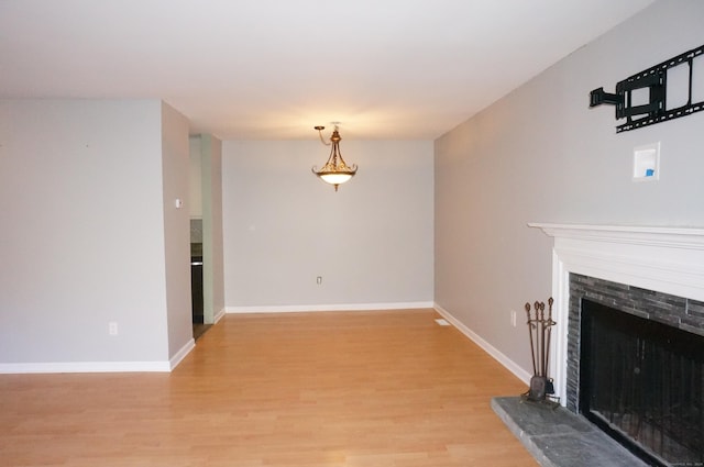 unfurnished living room featuring a fireplace and light wood-type flooring