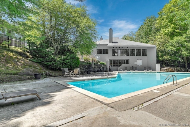 view of swimming pool featuring a patio area