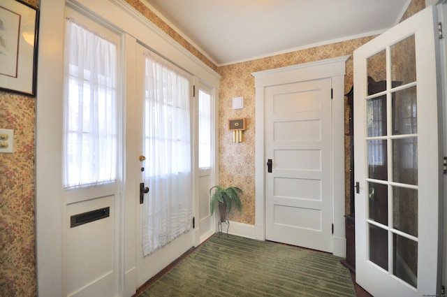 doorway featuring dark colored carpet and ornamental molding