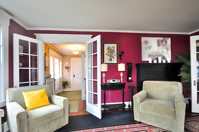 living area featuring hardwood / wood-style floors, french doors, and crown molding