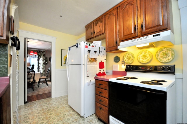 kitchen featuring white appliances and light hardwood / wood-style floors