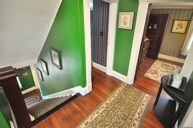 stairs featuring hardwood / wood-style floors