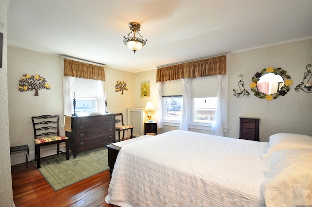 bedroom featuring dark hardwood / wood-style flooring and crown molding