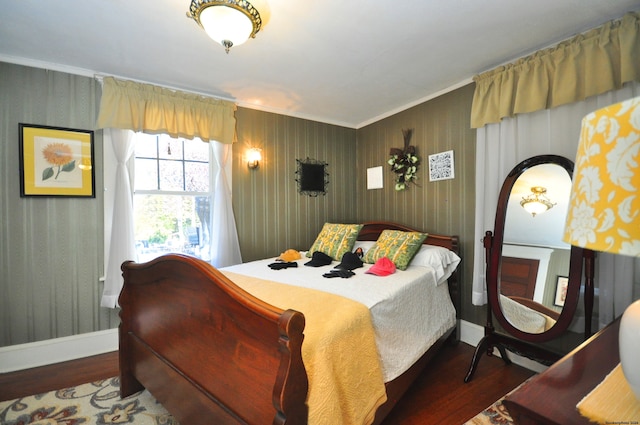 bedroom with dark hardwood / wood-style floors and crown molding