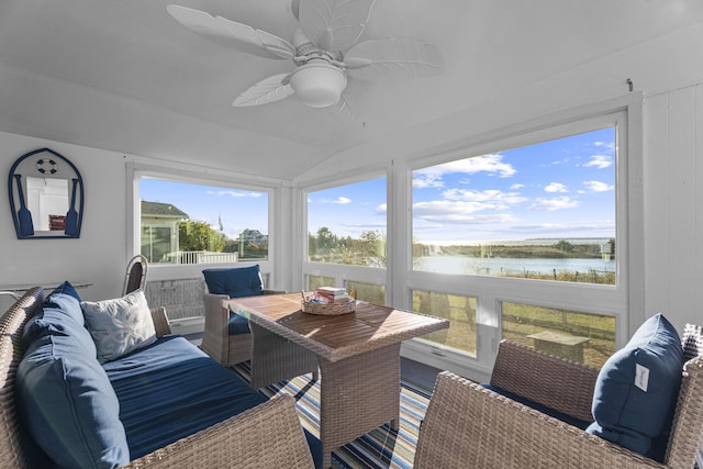 sunroom with a water view, vaulted ceiling, and a ceiling fan