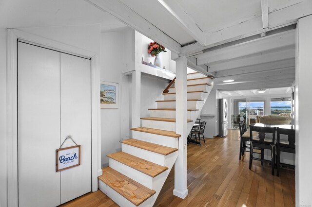 staircase with wood-type flooring