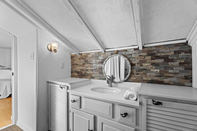 bathroom with hardwood / wood-style floors, vanity, and wood walls